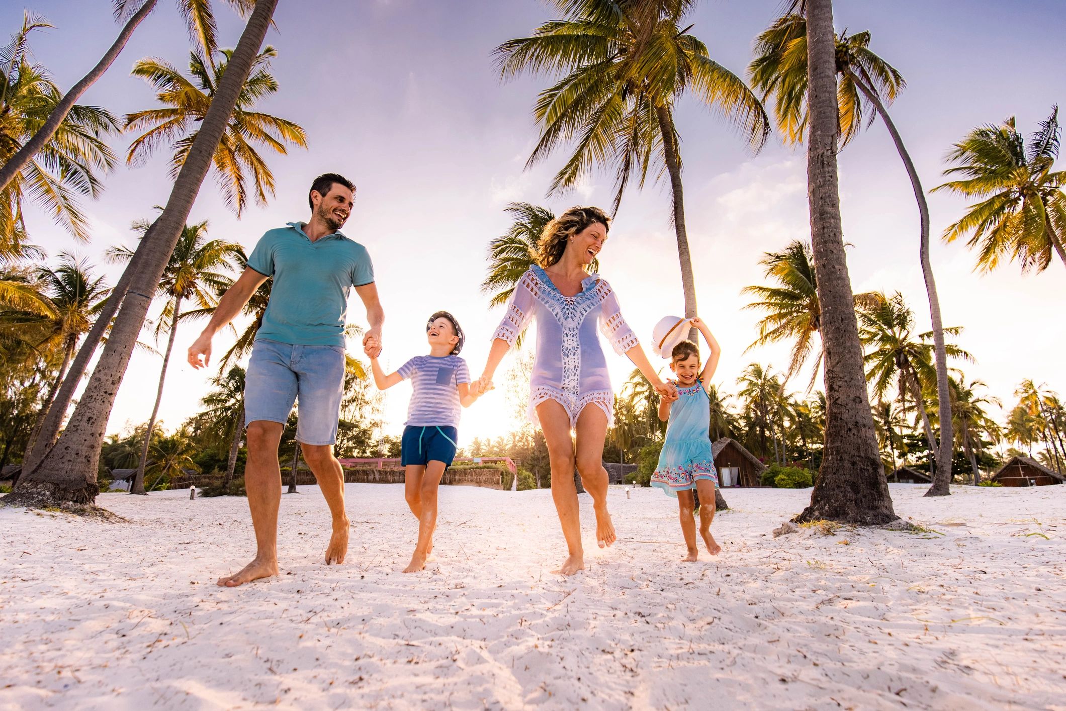 Family running together on the beach