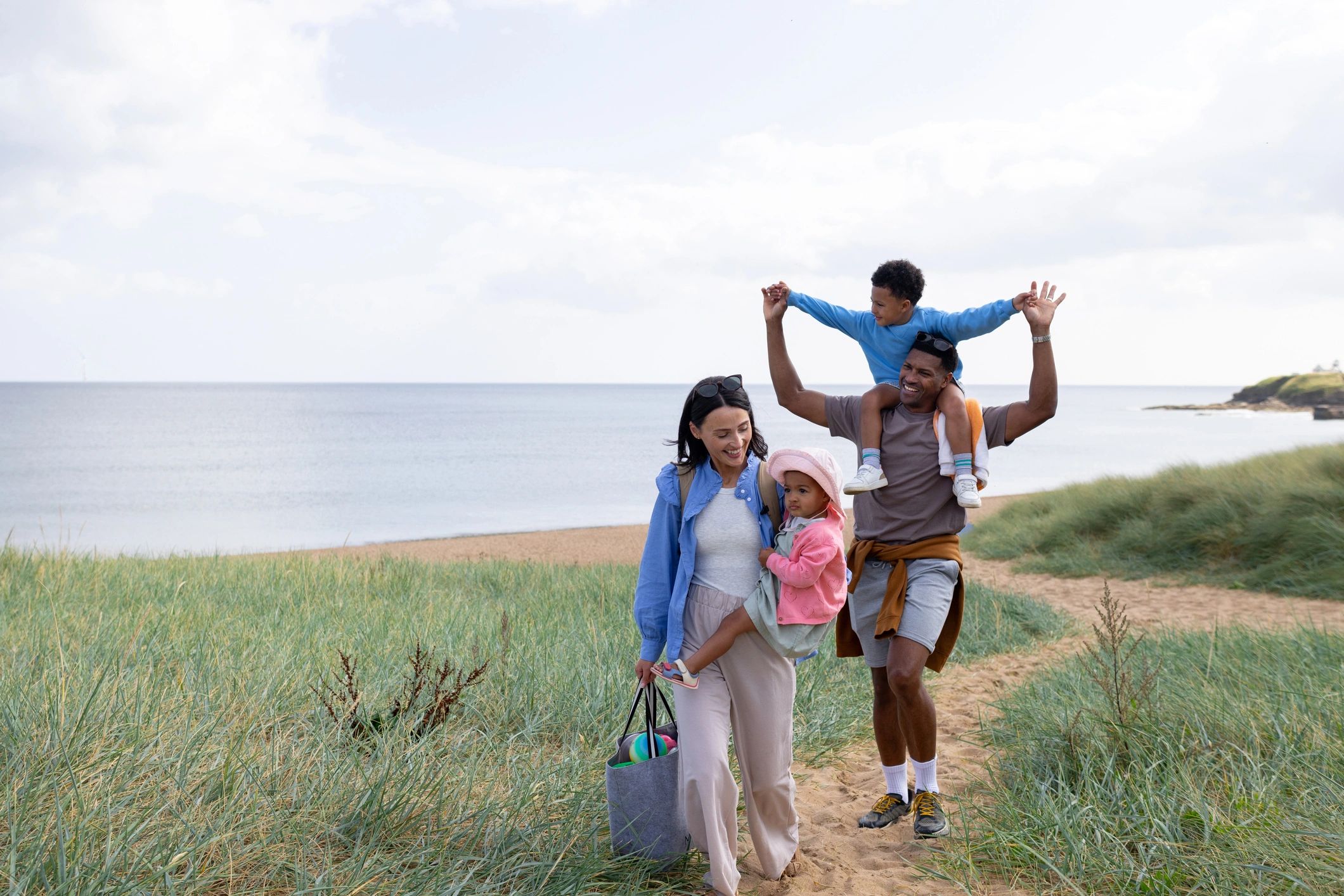 Family walking near a tropical beach path