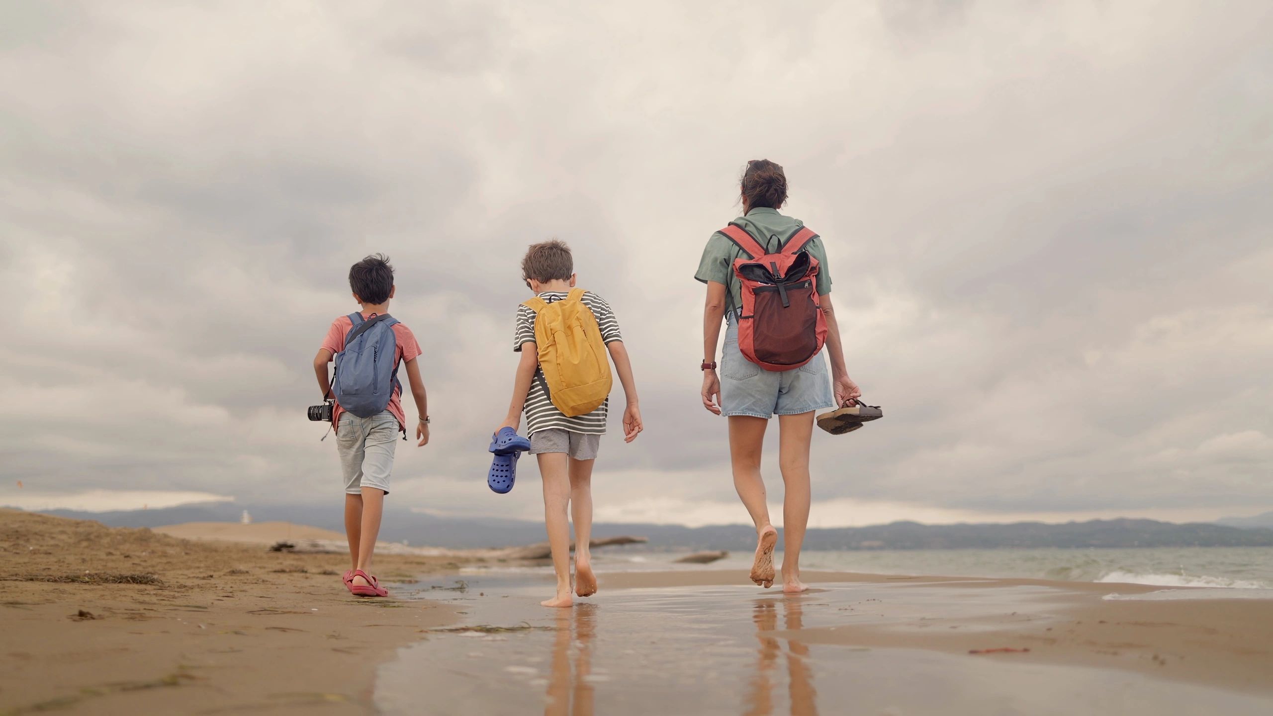 Family walking together along the beach